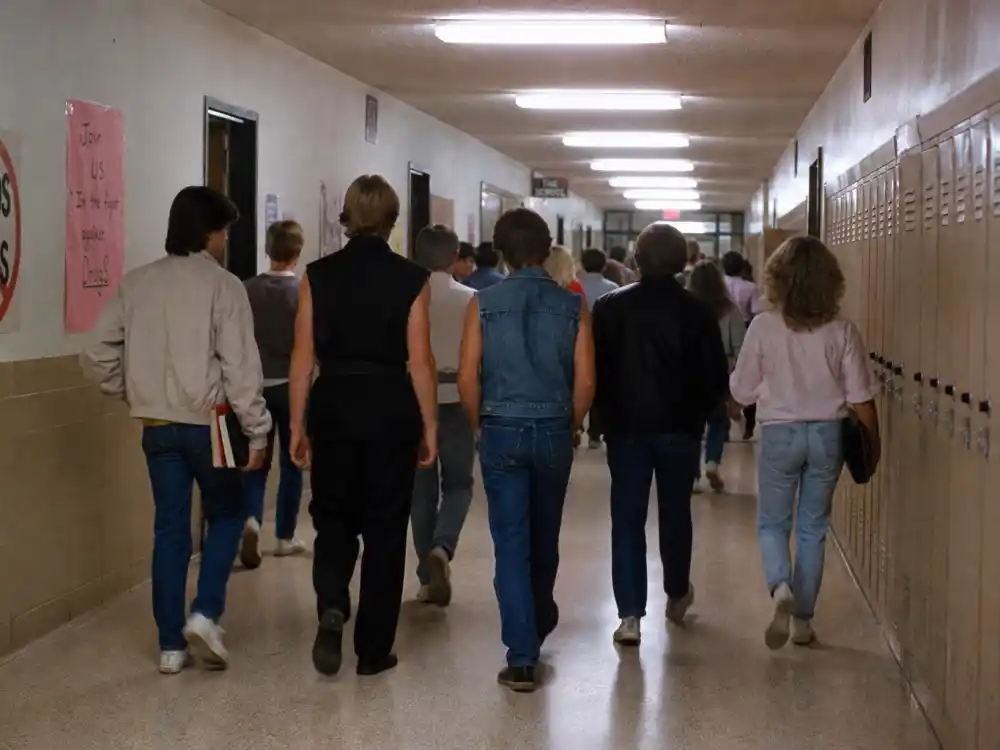 A 1980s American high school hallway evoking William Zabka Johnny Lawrence Karate Kid villain era