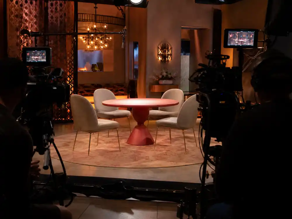 Talk show round table set from behind for Willow Smith celebrity kid career evolution Red Table Talk era editorial without identifiable faces