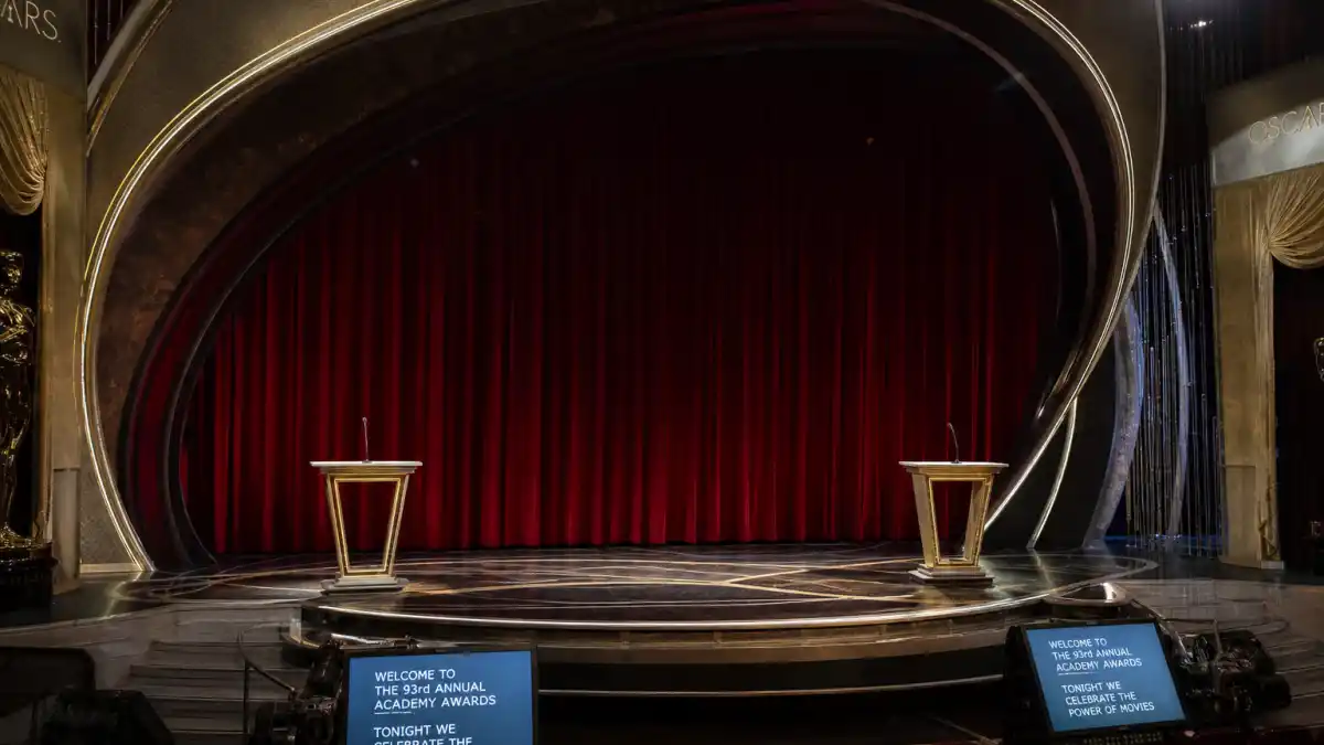 Worst award show hosting moments — empty Oscars stage with awkward dual podiums and harsh spotlight capturing live-TV hosting disasters