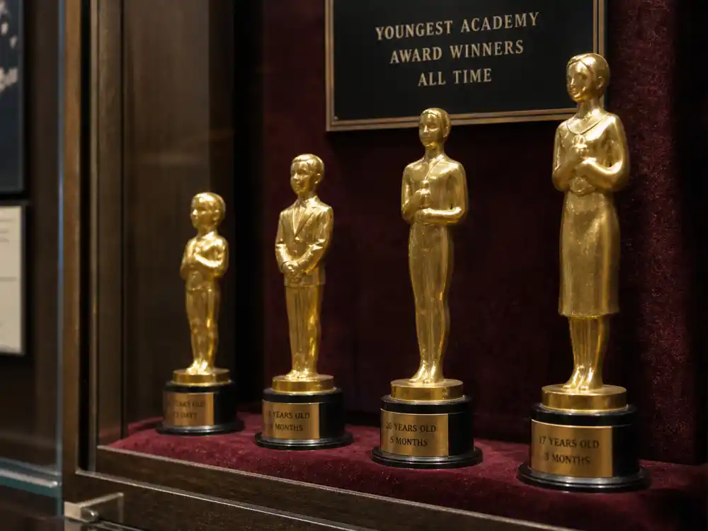 Velvet trophy case with golden statuettes symbolizing youngest Oscar winners of all time in Academy history