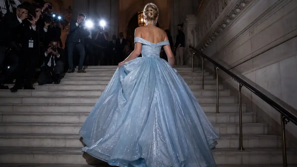 Zendaya Cinderella Met Gala dress — powder-blue ballgown photographed from behind ascending the Metropolitan Museum steps with camera flashes