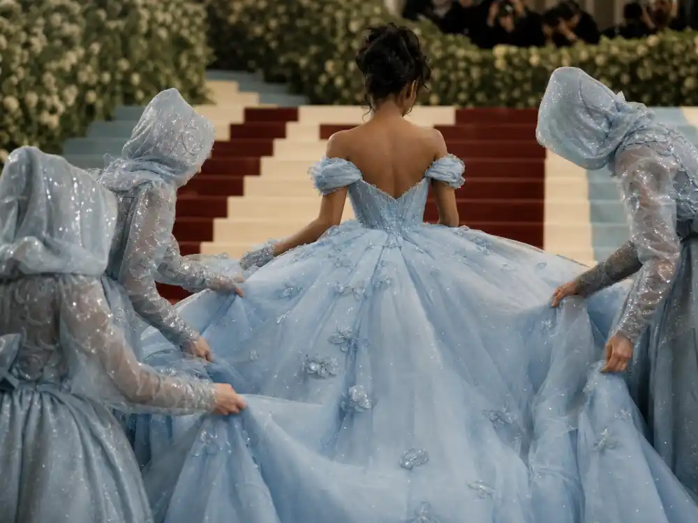 Live staircase transformation staging the Zendaya Cinderella Met Gala dress reveal on Metropolitan Museum marble steps at night
