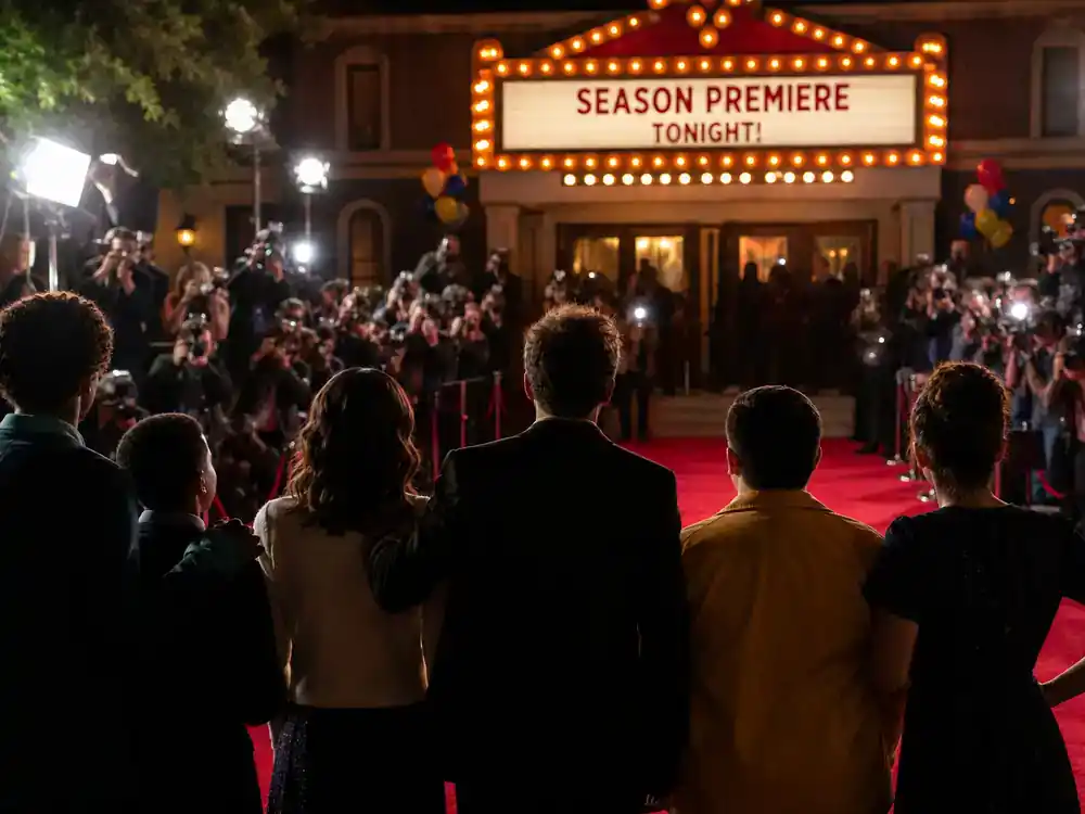 Abbott Elementary season 5 cast guide premiere — TV comedy red carpet cast silhouettes and photographers at season launch event from behind