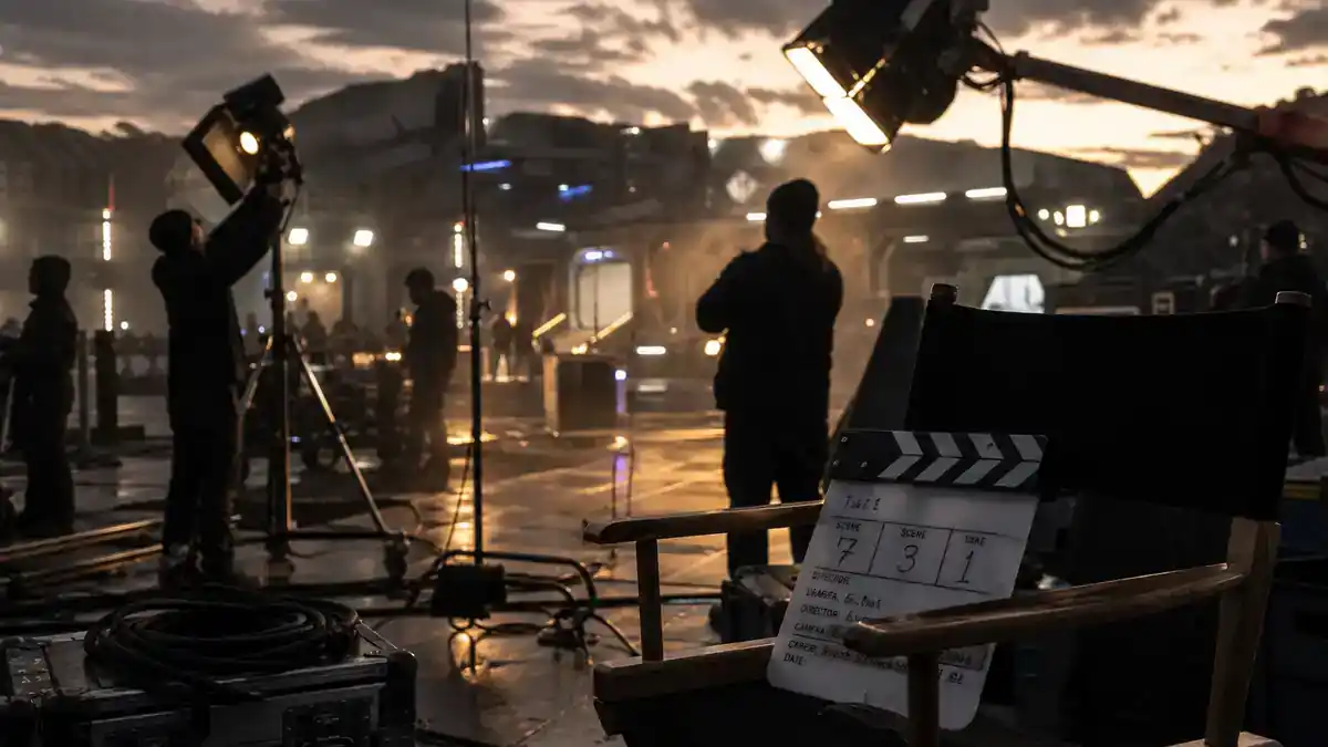 Andor season 2 cast and Star Wars timeline guide — sci-fi TV crew on futuristic industrial film set at dusk with clapperboard and director chairs, editorial production reference