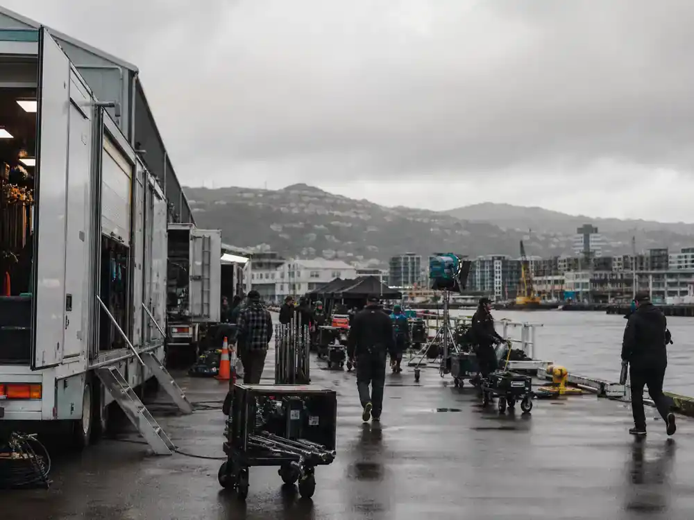Avatar 3 filming locations and cast updates New Zealand — production trucks at Wellington studio lot with crew unloading motion capture gear