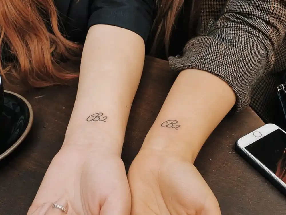 Bella Thorne tattoos and their meanings — BII script tattoo on ribcage photographed backstage from side angle