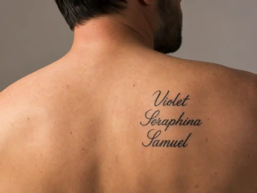 Ben Affleck tattoos and their meanings — Violet Seraphina Samuel script names on shoulder blade close-up