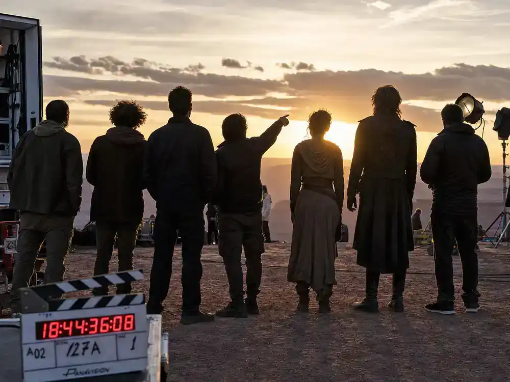 best celebrity performances of 2026 ranked ensemble cast — group silhouettes from behind on outdoor location set with film trucks and lighting rigs