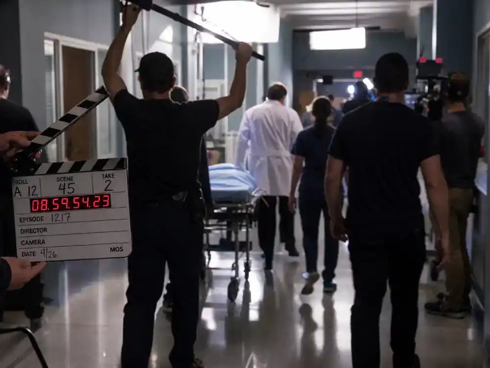 Best TV finales of 2026 ranked so far Grey's Anatomy — medical TV drama hospital corridor film set with clapperboard gurney and crew silhouettes