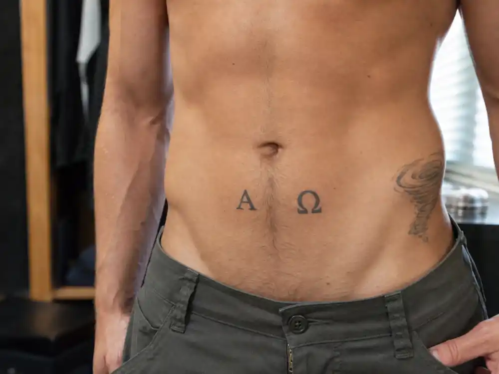 Brad Pitt tattoos and their meanings Alpha Omega — stomach Greek letters Alpha and Omega tattoo with tornado hip sketch on athletic torso
