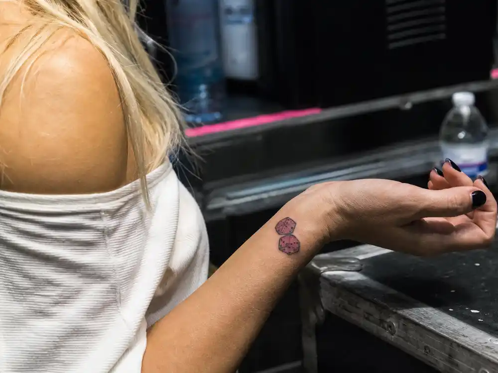 Britney Spears tattoos and their meanings dice wrist — pink matching dice tattoo with Kevin Federline on left wrist