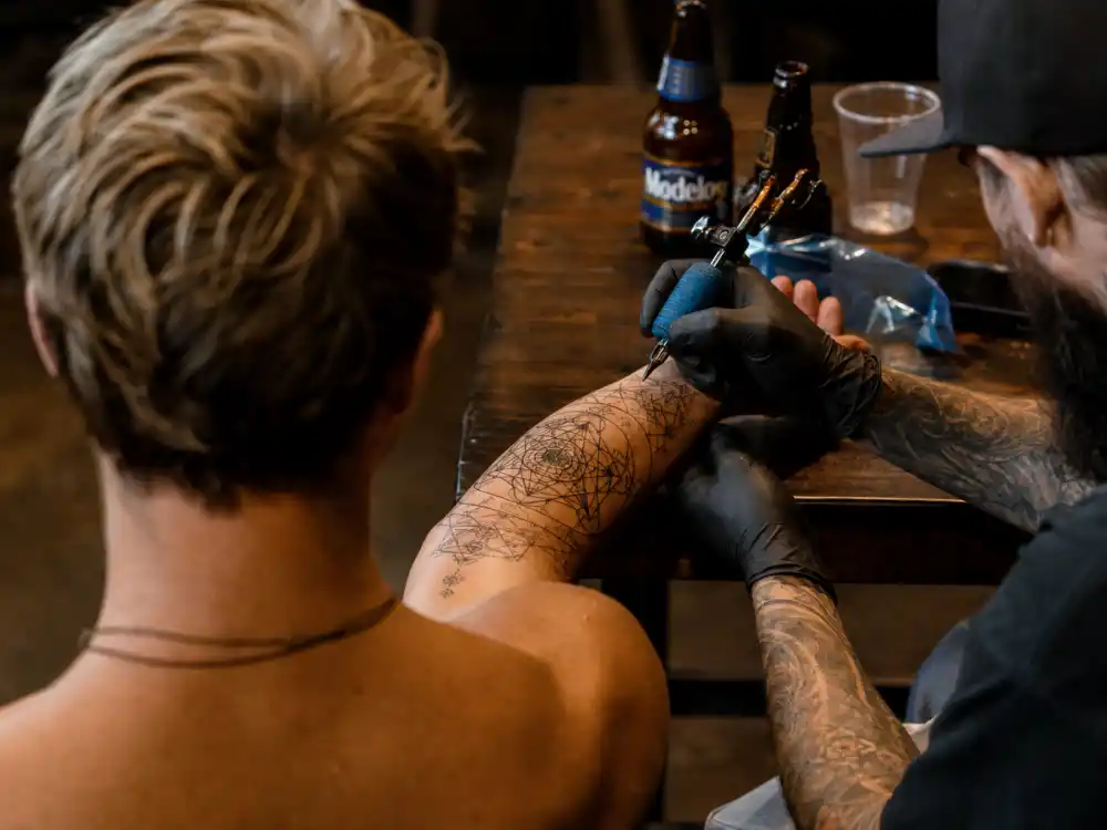 Chris Hemsworth tattoos and their meanings sacred geometry — intricate mandala tattoo on inner right forearm by Dillon Forte in studio session over-shoulder view