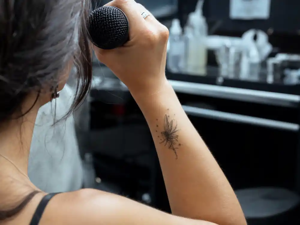 Christina Ricci tattoos and their meanings — fairy tattoo on right wrist photographed in backstage close-up
