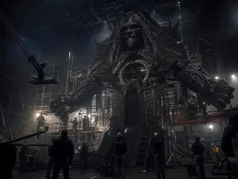 Fantastic Four First Steps cast and plot guide Galactus threat — massive practical effects rig on cosmic sci-fi film set with crew silhouettes adjusting structure