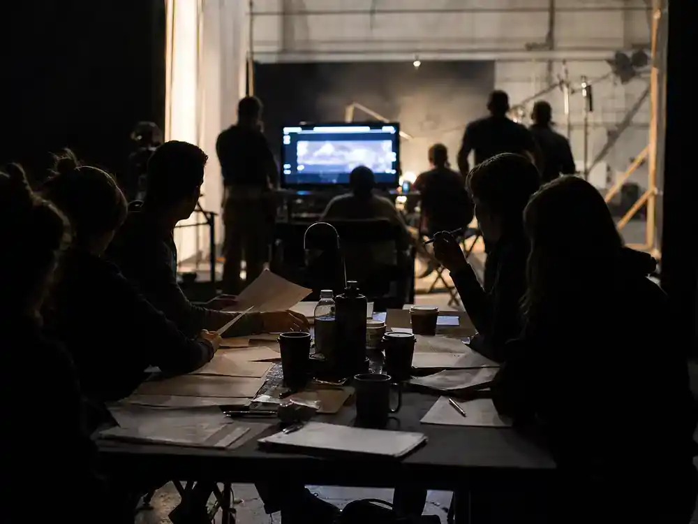 Fantastic Four First Steps cast and plot guide supporting cast — ensemble silhouettes rehearsing around conference table on film soundstage with scripts