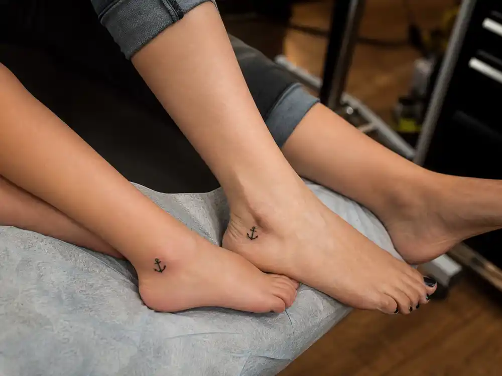 Halsey tattoos and their meanings — matching anchor foot tattoos with mother in first tattoo parlor session