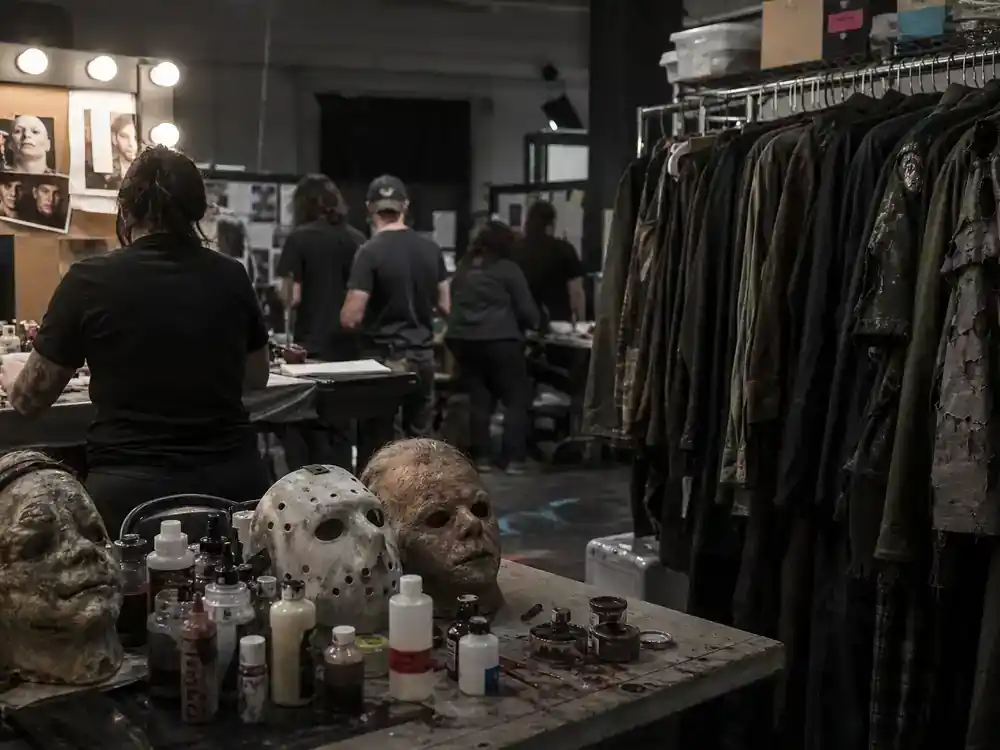 Horror franchise sequels 2026 cast guide slasher legacy — classic horror wardrobe department with generic costumes and makeup station on sequel soundstage
