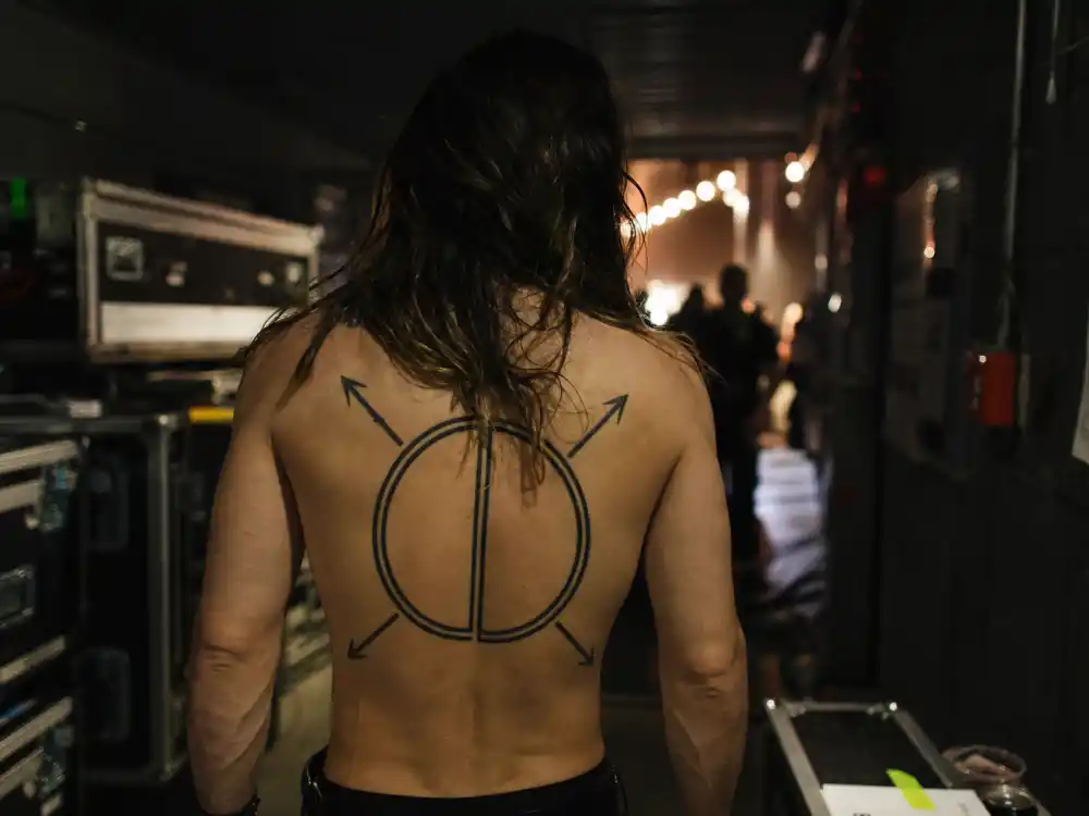Jared Leto tattoos and their meanings — Orbis Epsilon universe map geometric back tattoo from over-shoulder angle