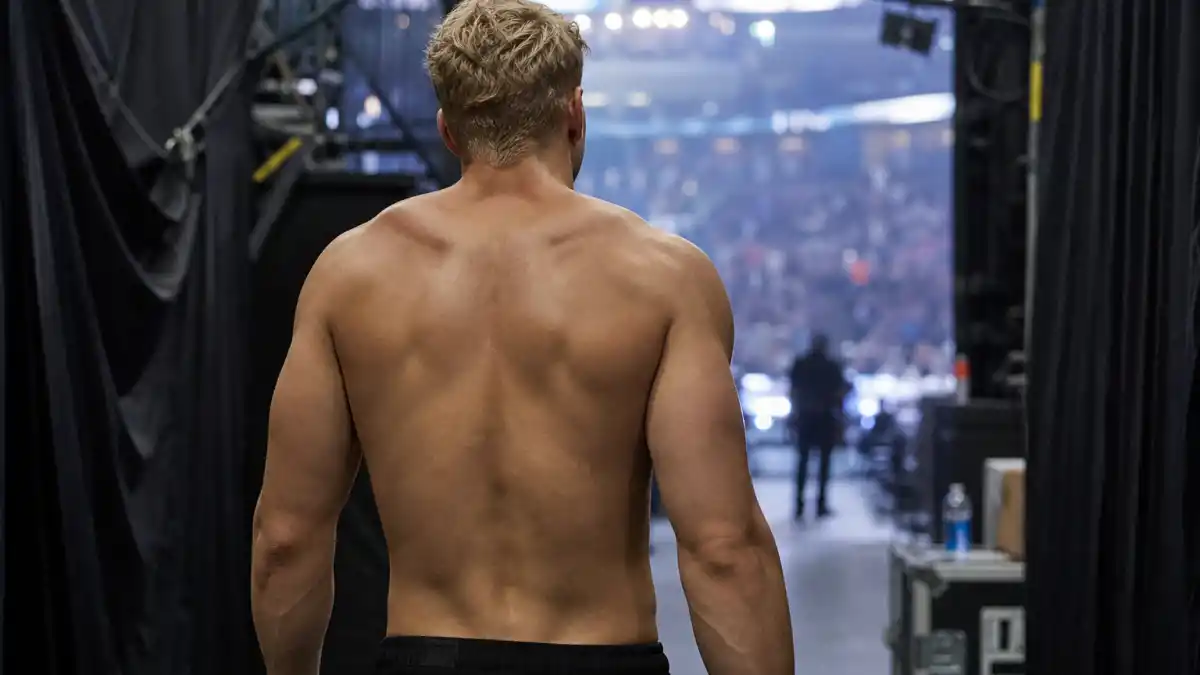 John Cena tattoos and their meanings — WWE star seen from behind entering arena with completely tattoo-free clean back and arms visible