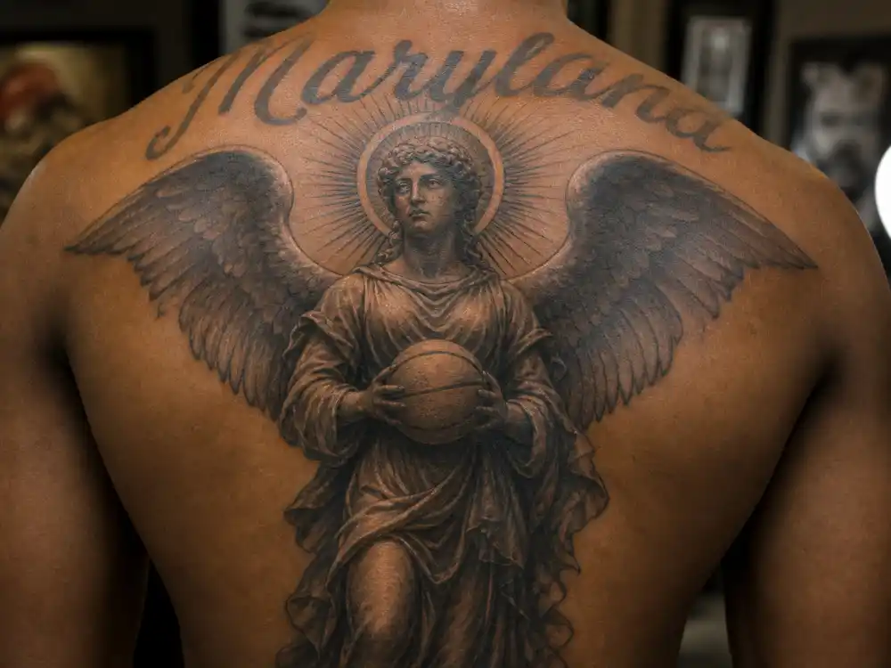 Kevin Durant tattoos and their meanings — angel holding basketball back tattoo tribute to late aunt
