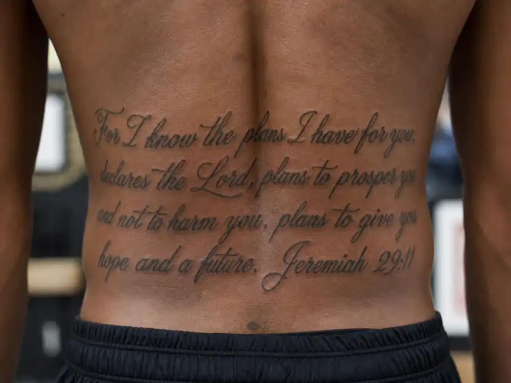Kevin Durant tattoos and their meanings — James 1:2-4 Bible verse script tattoo on lower back close-up