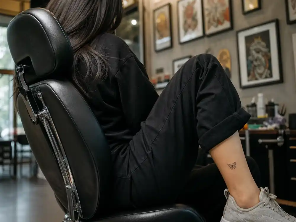 Kylie Jenner tattoos and their meanings — matching black butterfly ankle tattoo with Travis Scott documented in 2017