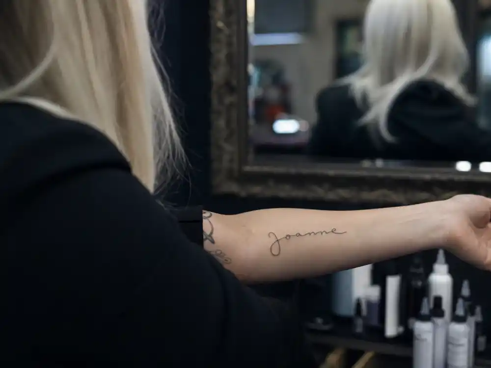 Lady Gaga tattoos and their meanings — Joanne signature tattoo in aunt handwriting on left forearm family tribute