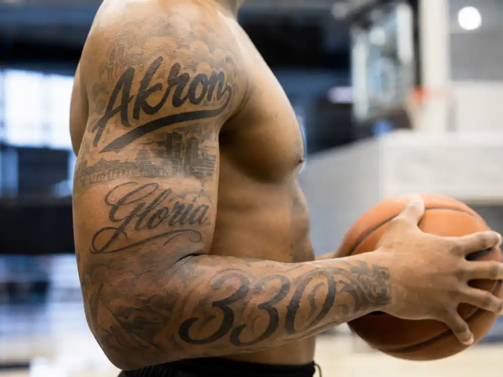 LeBron James tattoos and their meanings — Akron 330 and Gloria name tattoos on right shoulder and forearm