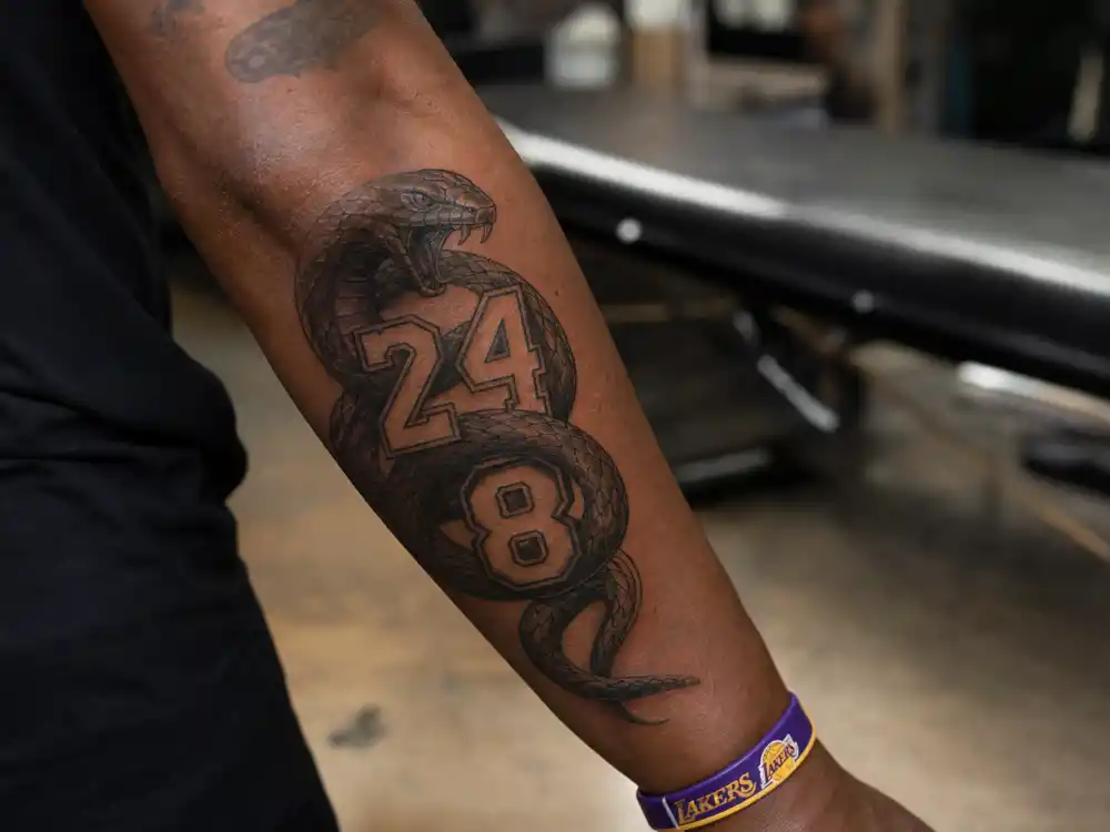 LeBron James tattoos and their meanings — black mamba snake with 24 and 8 Kobe Bryant tribute forearm tattoo