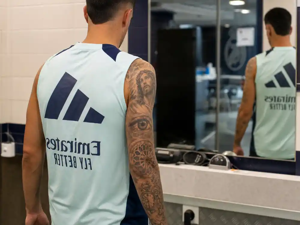 Lionel Messi tattoos and their meanings arm sleeve — right arm over-shoulder view with eye design, rose window, floral motifs and pocket watch tattoo