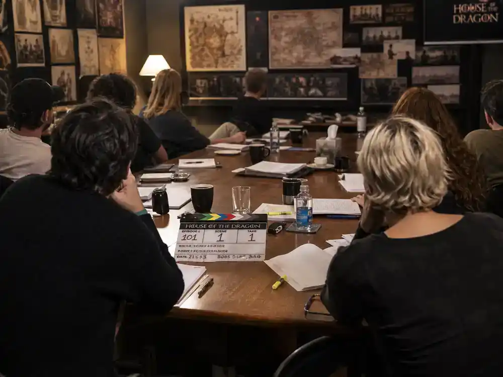 Lord of the Rings Rings of Power cast guide Elrond Celebrimbor — cast silhouettes from behind at table read in production office with scripts and clapperboard