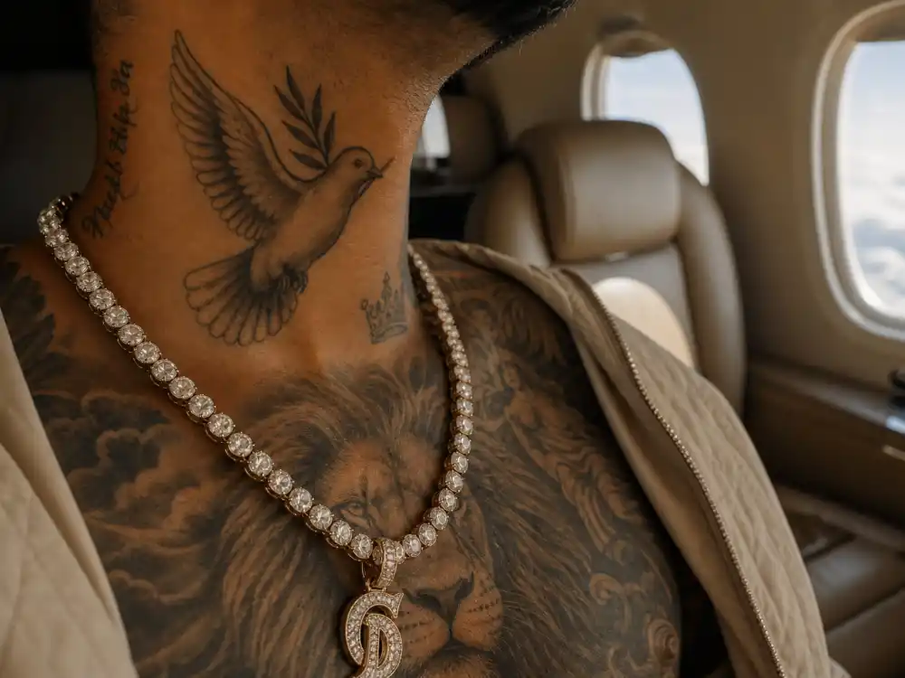 Maluma tattoos and their meanings — dove peace tattoo on neck and lion chest ink visible in private jet cabin over-shoulder angle