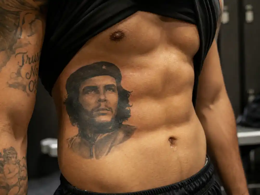 Mike Tyson tattoos and their meanings — Che Guevara portrait tattoo on left abdomen from iconic Guerrillero Heroico photograph