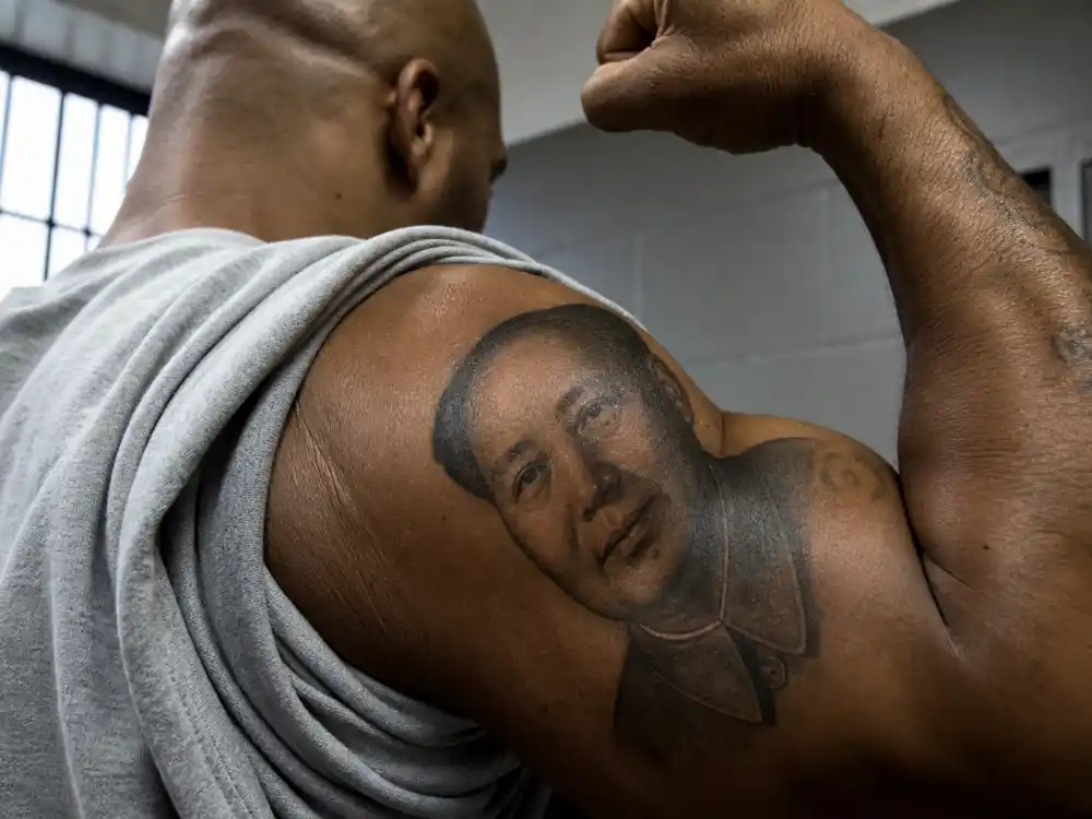 Mike Tyson tattoos and their meanings — Chairman Mao Zedong portrait tattoo on right bicep from prison-era reading