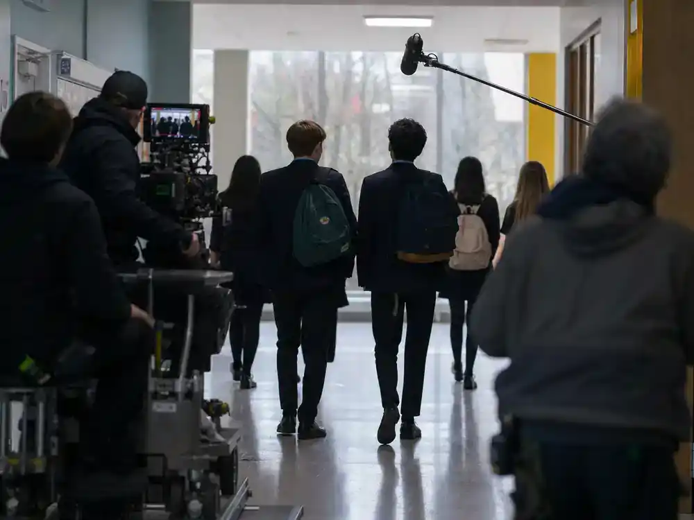 Netflix movies coming in July 2026 Heartstopper Forever — high school hallway film set with young cast silhouettes and camera dolly from behind