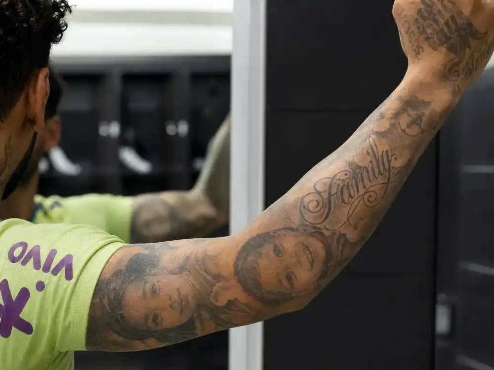 Neymar tattoos and their meanings family tribute — portrait tattoos and Family script on forearm mirror close-up