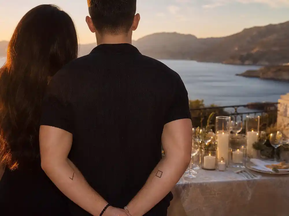 Nick Jonas tattoos and their meanings — checkmark and box matching tattoos with wife Priyanka Chopra Jonas on Crete terrace