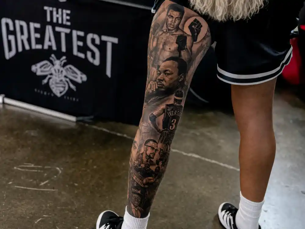 Odell Beckham Jr tattoos and their meanings — leg sleeve cultural icon portraits including Ali Iverson and raised fist symbols