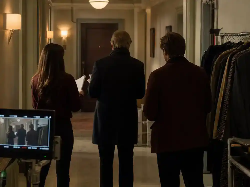Only Murders in the Building season 5 cast guide core trio — podcasters silhouettes recording microphones in apartment living room mystery TV set
