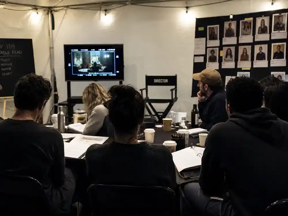 Only Murders in the Building season 5 cast guide guest stars — TV premiere red carpet cast silhouettes from behind with photographers at night