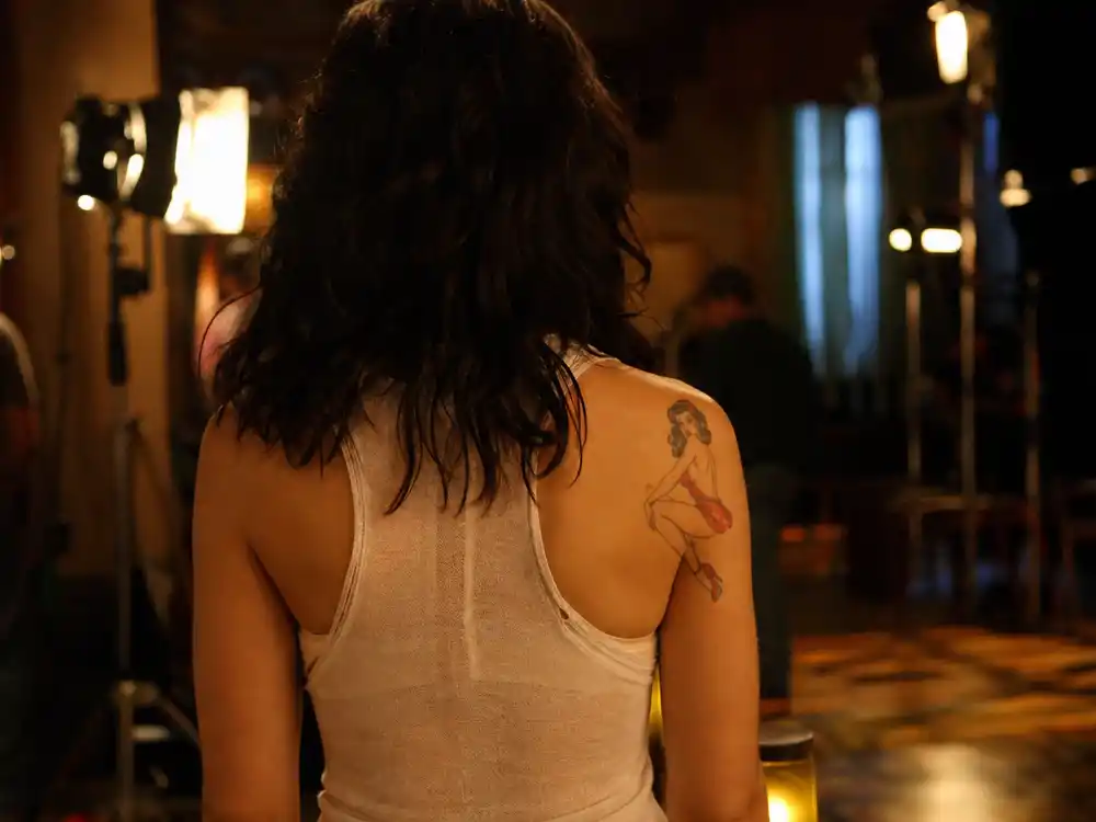 Rose McGowan tattoos and their meanings Charmed era — shoulder pin-up tattoo visible during WB television production years