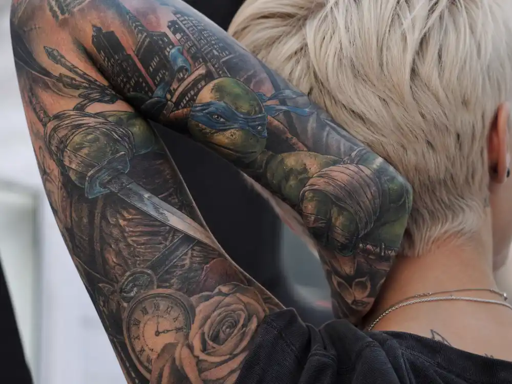 Ruby Rose tattoos and their meanings Leonardo — Teenage Mutant Ninja Turtle forearm tattoo childhood kindred spirits symbolism