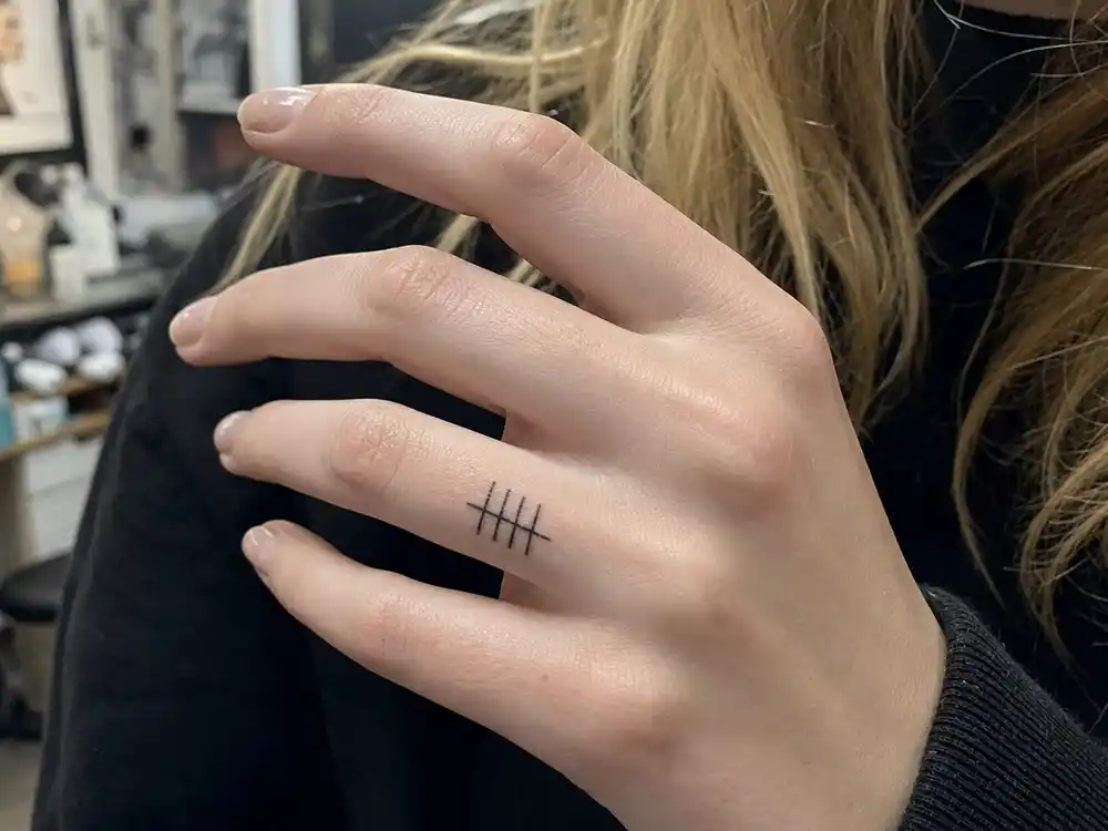 Sophie Turner tattoos and their meanings tally family — five cross-mark tattoos on ring finger representing parents, two brothers, and herself