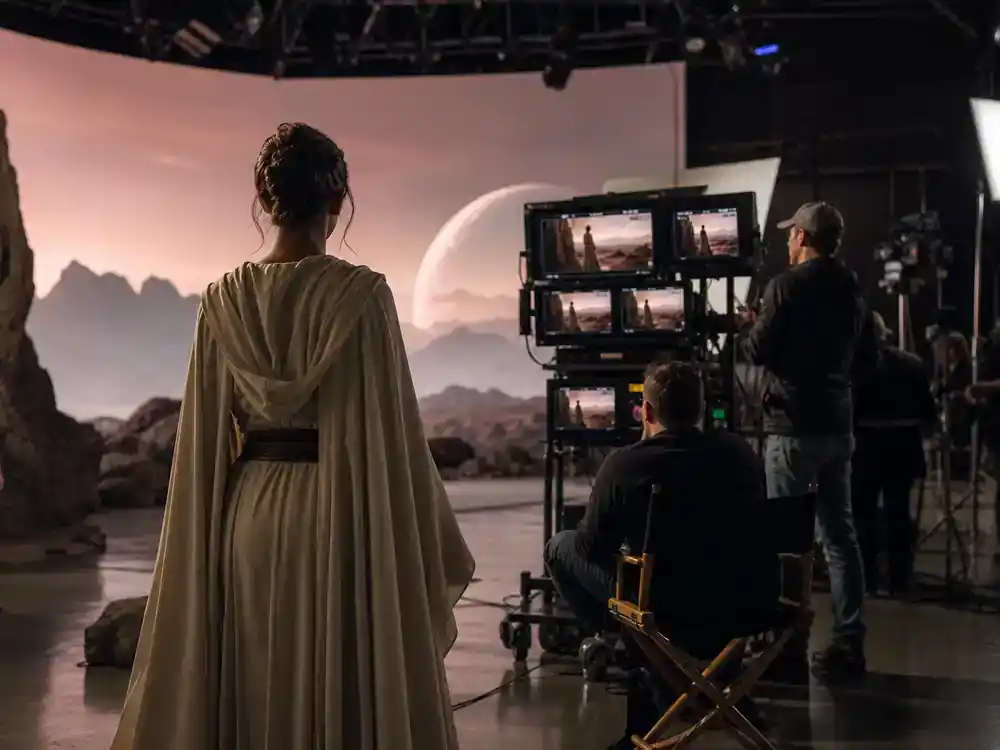 Star Wars upcoming movies and cast guide New Jedi Order — actor silhouette from behind in flowing Jedi robe on sci-fi film soundstage facing director monitors
