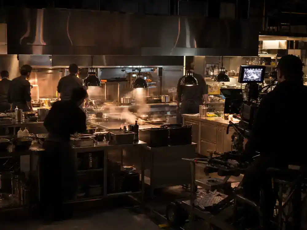 The Bear season 4 cast and kitchen guide kitchen — bustling professional restaurant kitchen TV drama film set with chef crew silhouettes at stainless stations