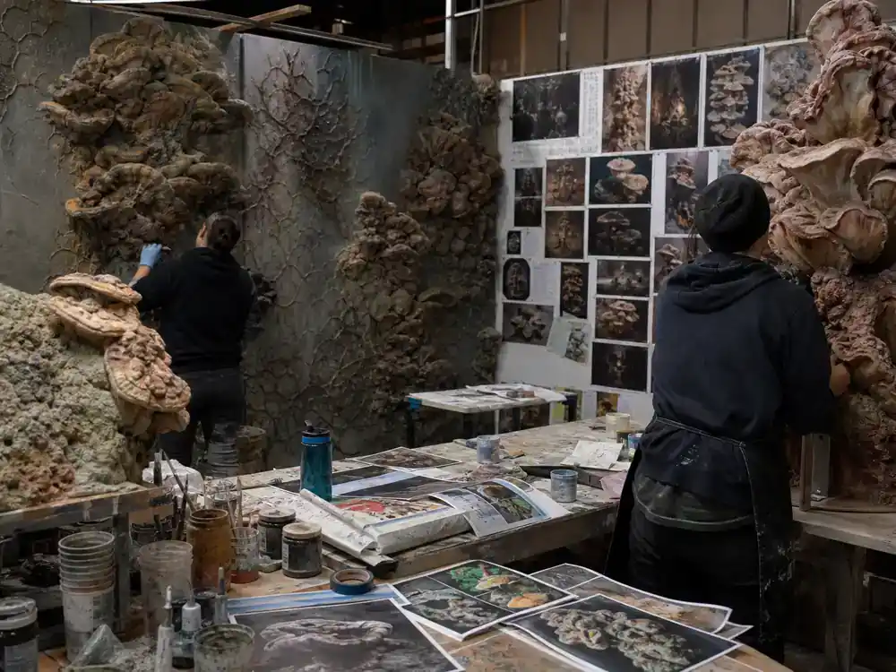 The Last of Us behind the scenes filming facts Cordyceps set design — art department sculptors from behind building fungal growth practical effects on walls