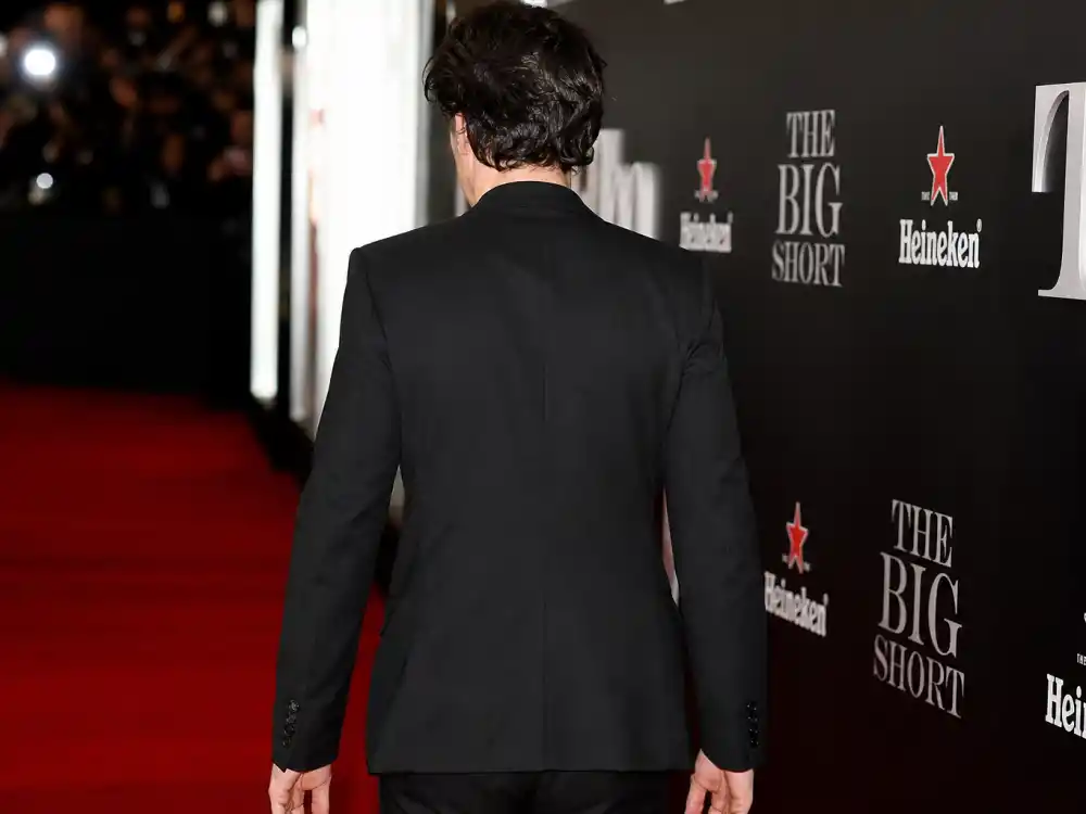 The Weeknd tattoos and their meanings — red carpet premiere from behind showing clean neck and bare hands without visible ink