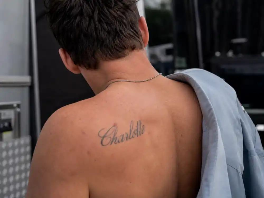 Tom Hardy tattoos and their meanings — Charlotte name script tattoo on shoulder tribute to wife Charlotte Riley