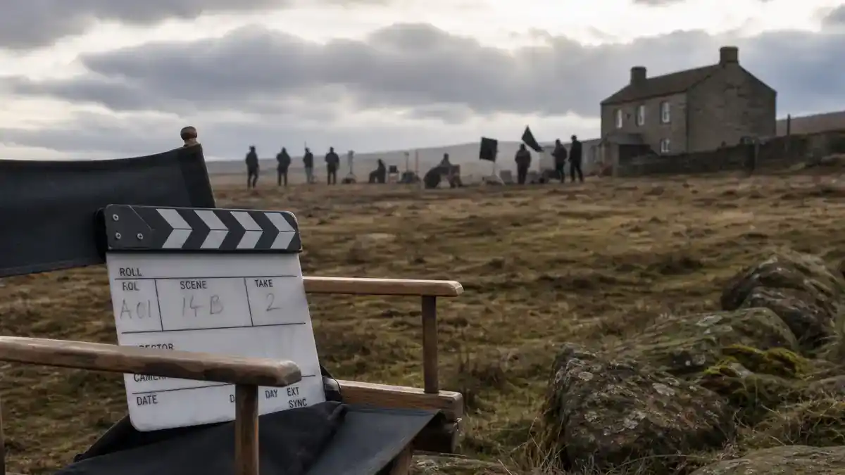 Wuthering Heights Margot Robbie movie cast guide — period drama film crew on Yorkshire moor with clapperboard and director chairs, editorial production reference