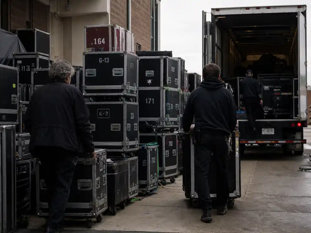 Tour road cases in a loading bay tracing Adele net worth over the years through live eras